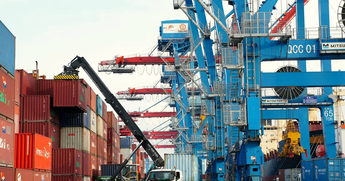 Forklift and shipping containers at an industrial yard in Pakistan