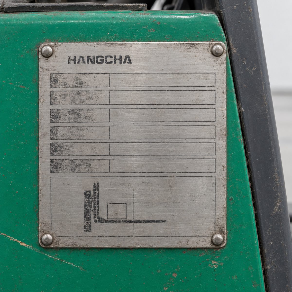 Close-up of a forklift data plate with the Hangcha brand name, other details blurred