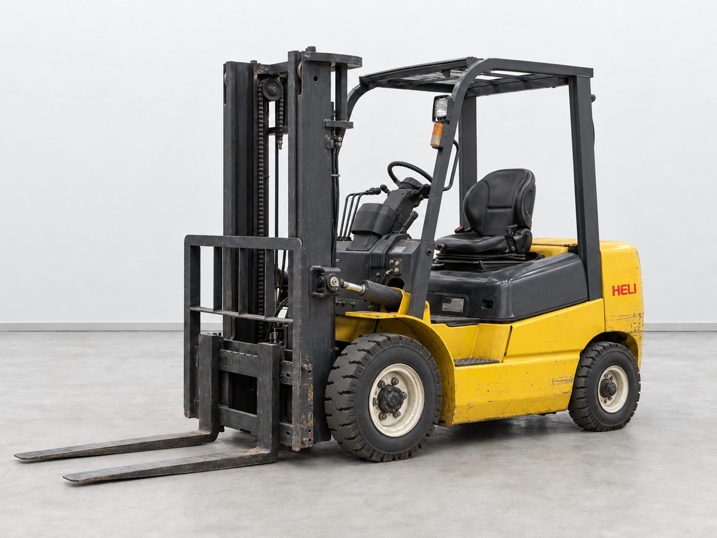 Used yellow Heli forklift with black mast and overhead guard, seen from the front left