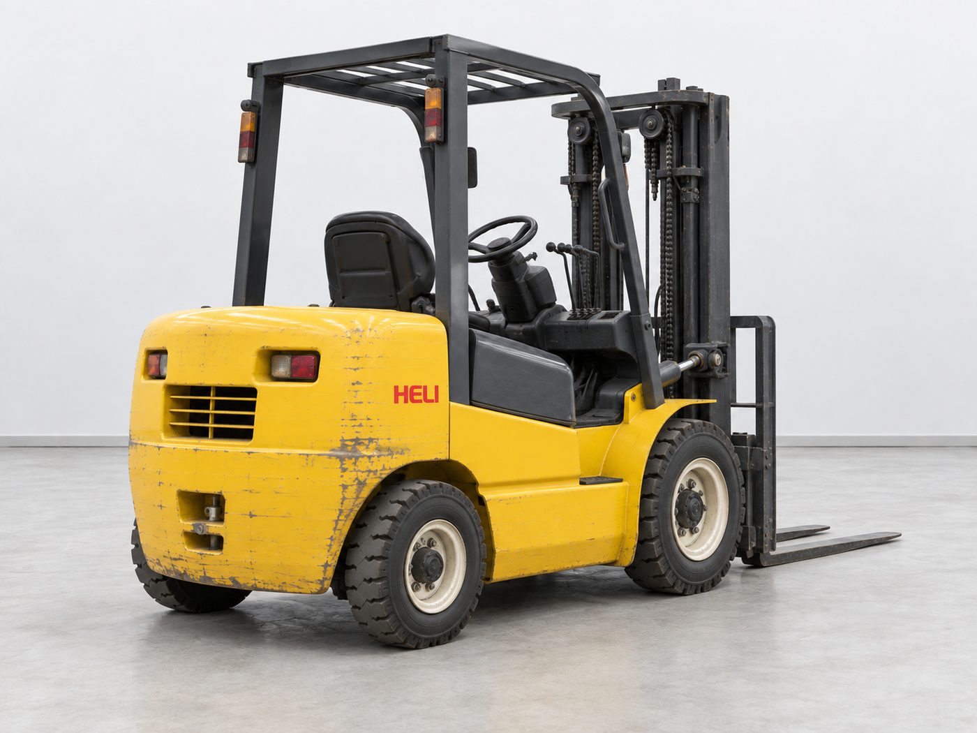 Rear view of a used yellow Heli forklift showing the counterweight, rear lamps and steer tyres