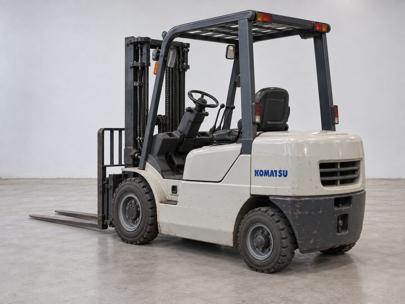 Rear three-quarter view of a used Komatsu forklift showing the counterweight and rear tyres